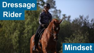 A person rides a chestnut horse outdoors, wearing a helmet and patterned shirt. Blue boxes with white text read “Dressage Rider” and “Dressage Mindset.” Trees and a blue sky complete this elegant equestrian scene.
