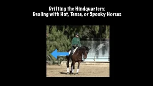 A rider on a dark horse in an arena, with an arrow pointing left to the horse’s hindquarters. Text above reads, Drifting the Hindquarters: Managing Spooky Horses. Trees and a fence are in the background.