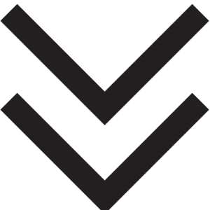 Two bold black downward-pointing chevrons stacked vertically on a light gray background, resembling a double down arrow symbol often used in Dressage Training diagrams.