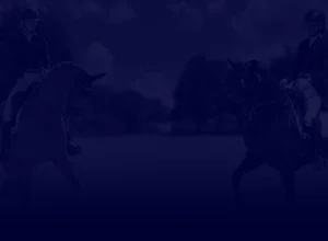 Two people in equestrian attire ride horses in an open grassy field under a partly cloudy sky, set against a dark blue overlay—perfect imagery for a Training Scale masterclass.