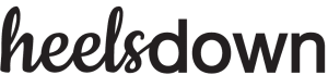 The word heelsdown is written in a bold, black, cursive and sans-serif mixed font on a light background, evoking the elegance of Dressage Training.