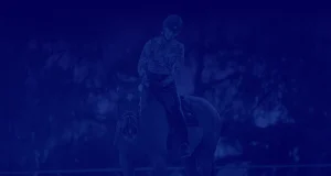 A person wearing a helmet rides a horse outdoors, surrounded by trees. With its dark blue overlay and monochromatic appearance, the scene captures the spirit of Strides 2024 in motion.