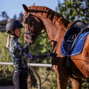 Amelia Newcomb working on groundwork with a chestnut dressage horse.