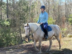 Melissa Hunter Ensor taking her horse on a trail ride.