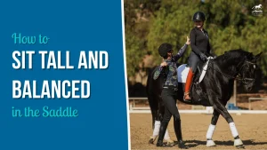 A trainer gives a high five to a smiling equestrian who is sitting tall on a black horse during a riding lesson. Text on the left reads, How to sit tall and balanced in the saddle with riding tips to improve riding posture.