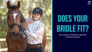 A smiling person wearing a riding helmet stands next to a brown horse holding its bridle. Text reads: Does your horse bridle fit? Discover six bridle fitting tips for optimal fit and comfort.
