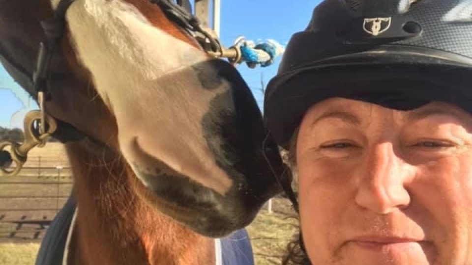 Online student GinaLee posing with her horse.